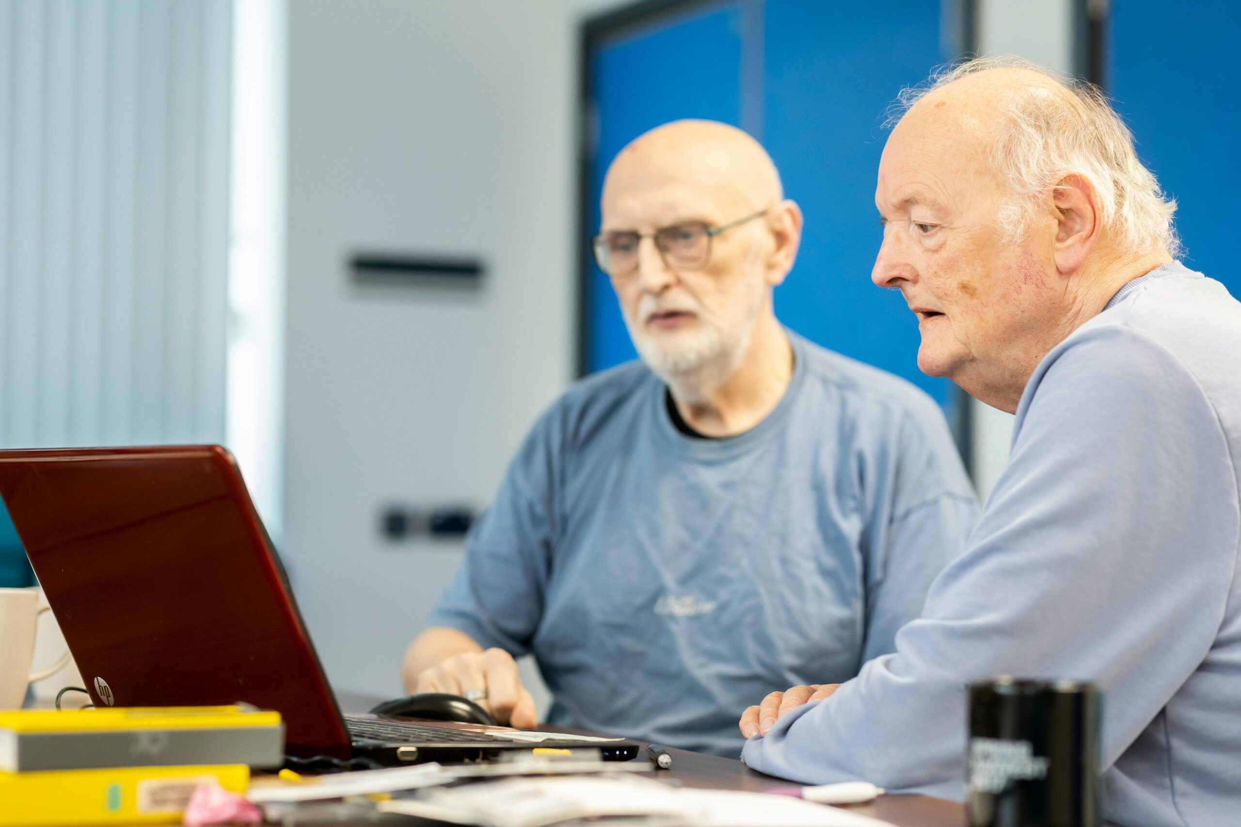 Elderly Men Sitting at Desk