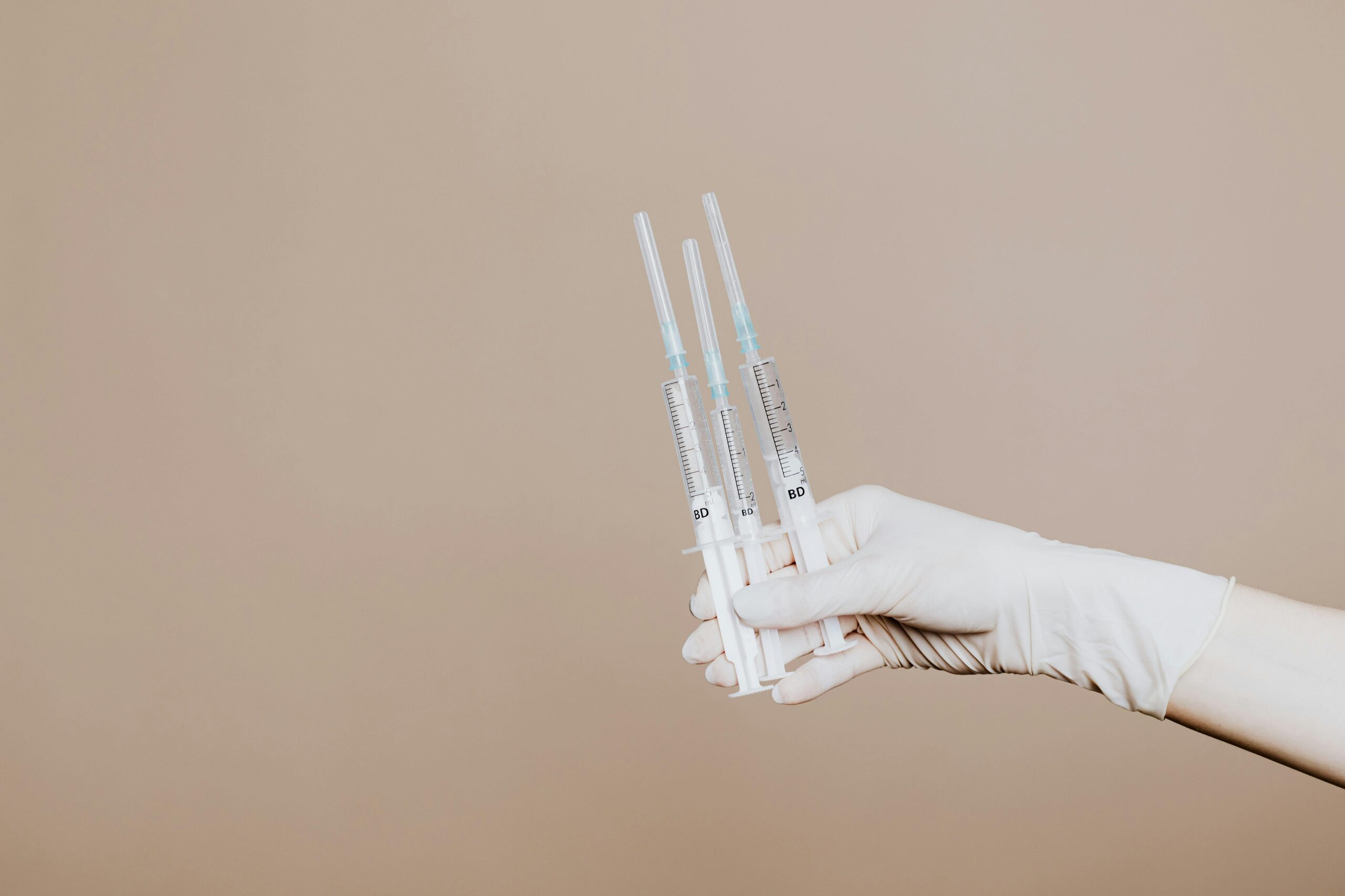 Person Holding Three Syringes